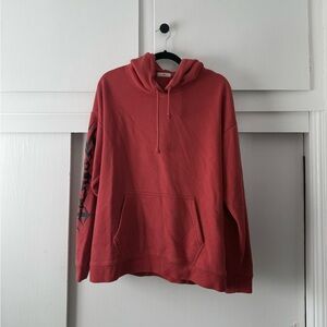 Aritzia TNA Brick Red Hoodie with Black Graphic